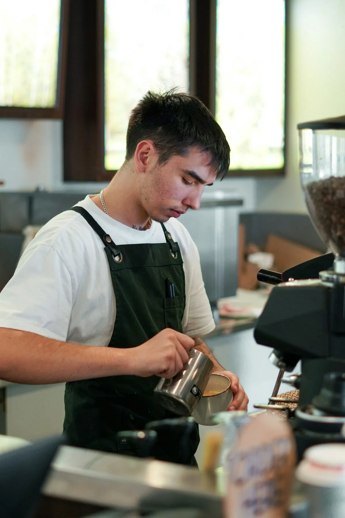 Barista preparing coffee at espresso machine