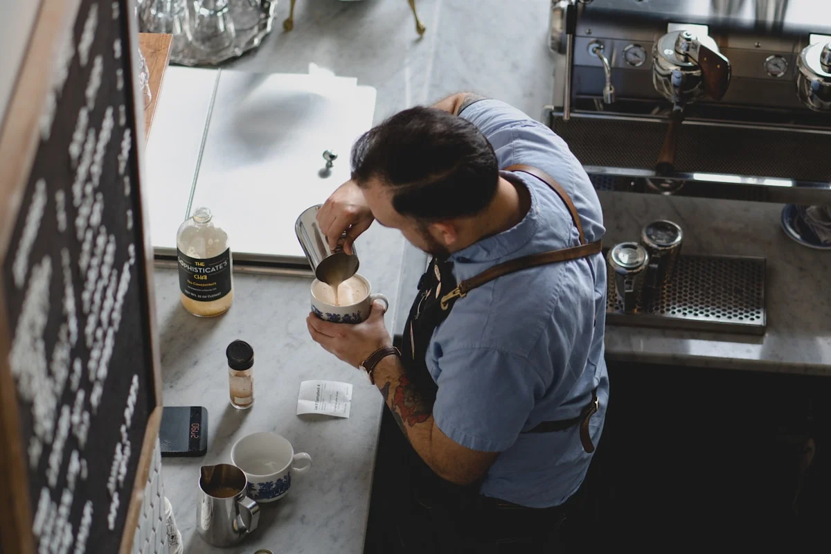 Cozy cafe interior with barista at work