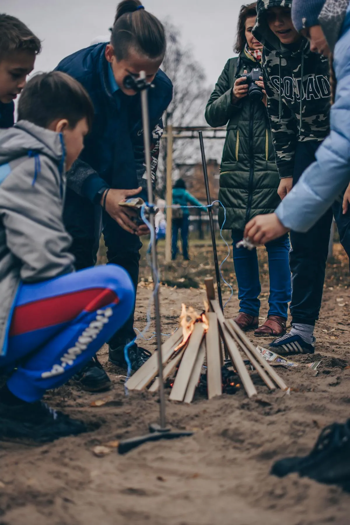Children learning fire lighting in forest school