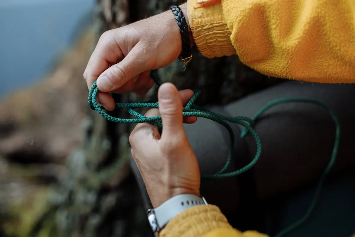 Hands tying rope knot