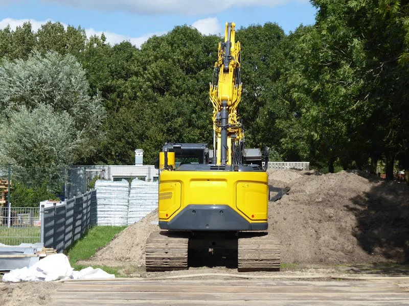 Yellow excavator on construction site