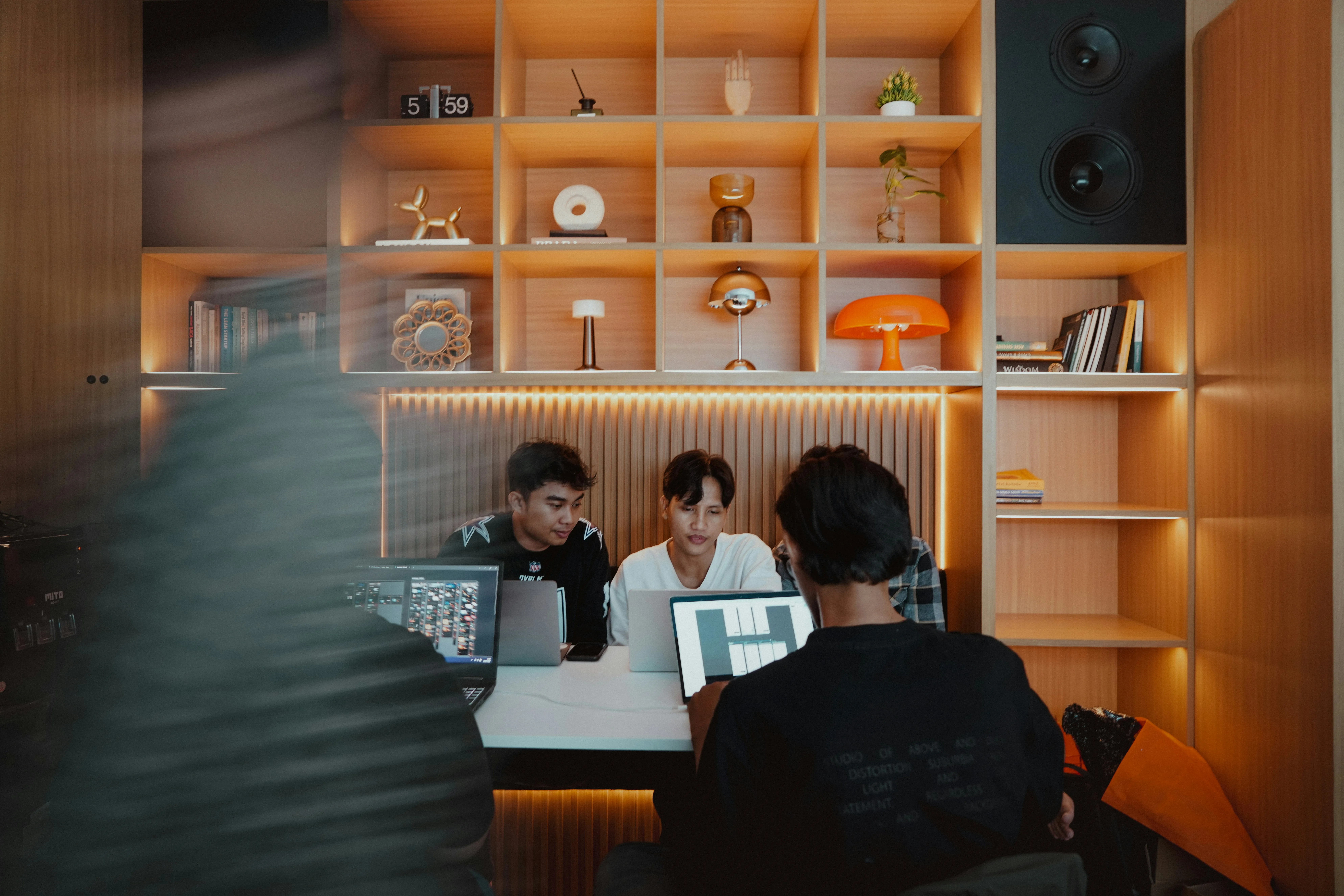 Team collaborating on creative project with computer displays