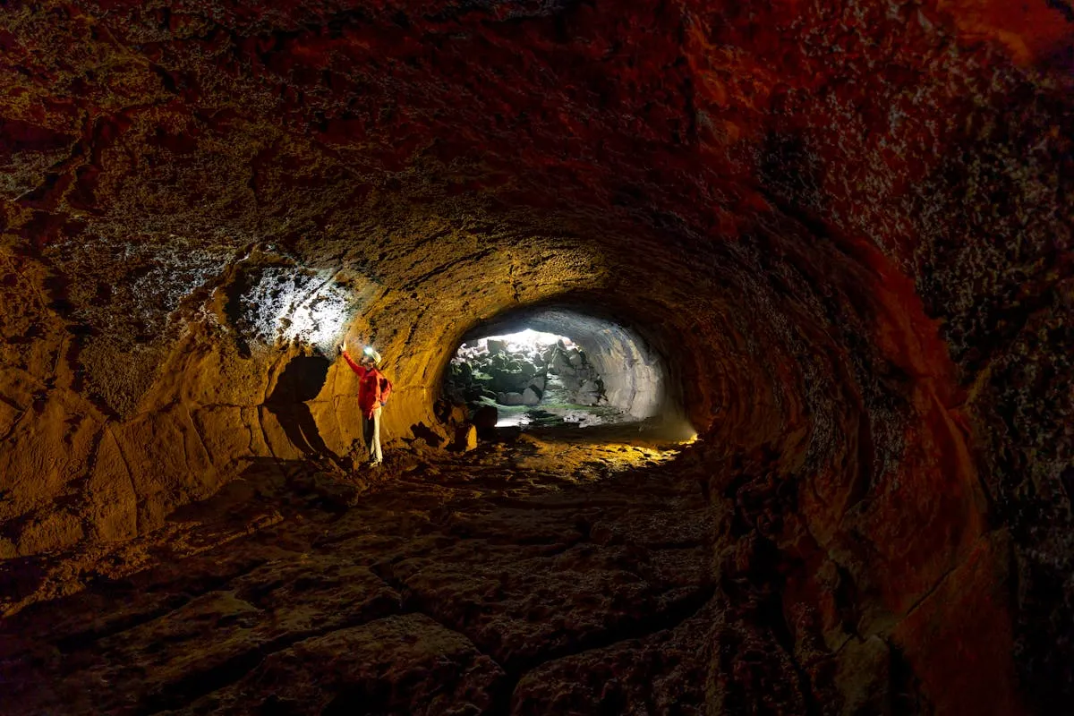 Person exploring a cave with headlamp