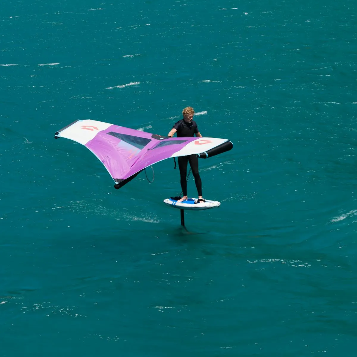 Wing foiler riding above the water