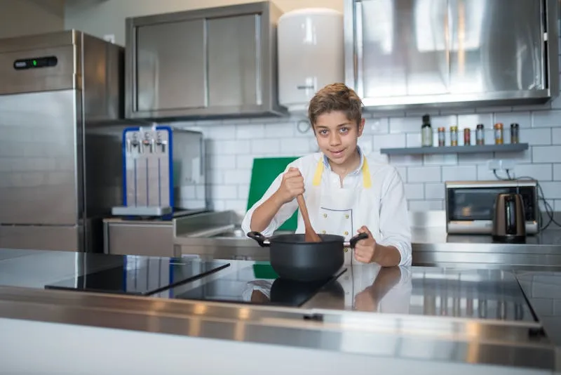 Student cooking in school kitchen