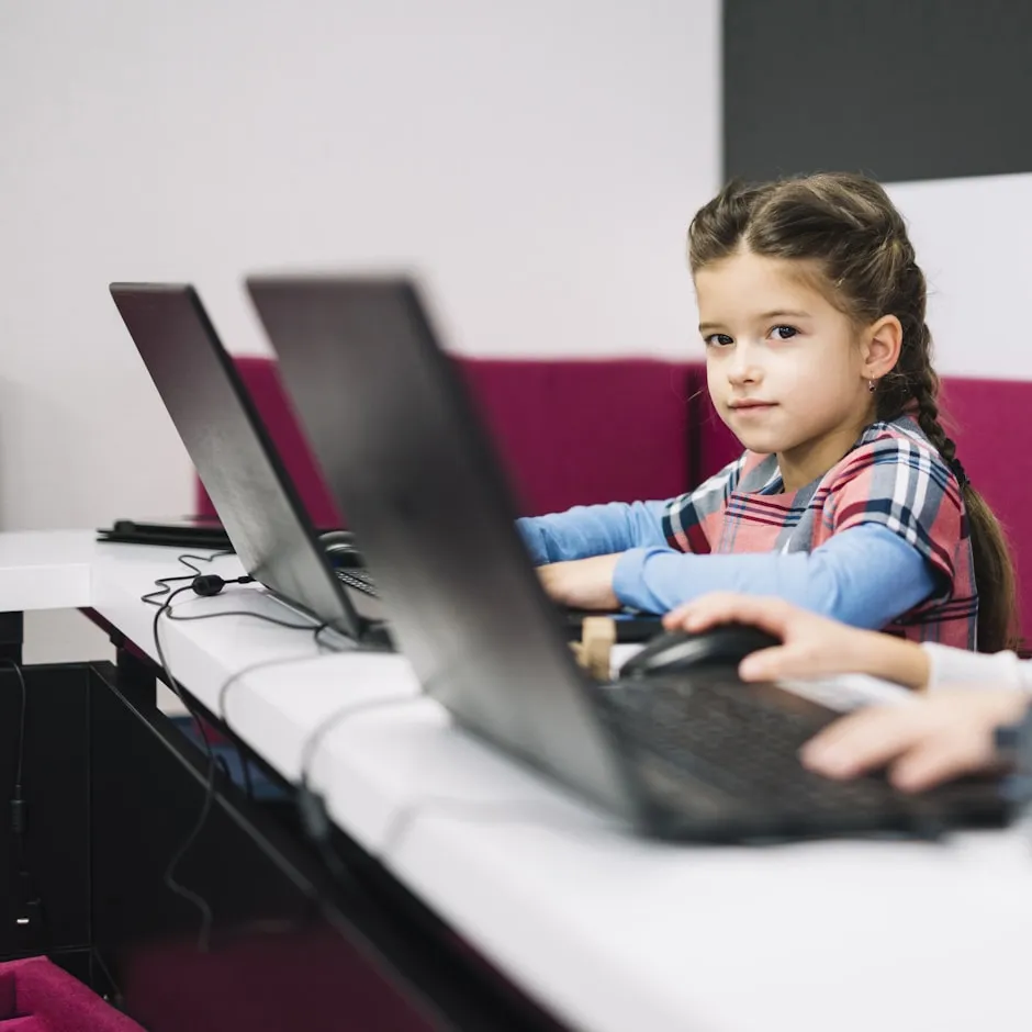 Teacher supervising safe computer use