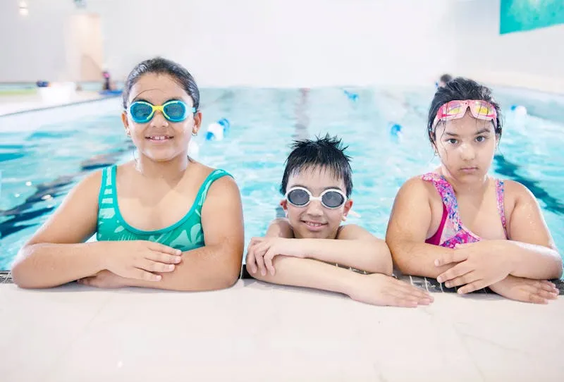 Children learning to swim in pool