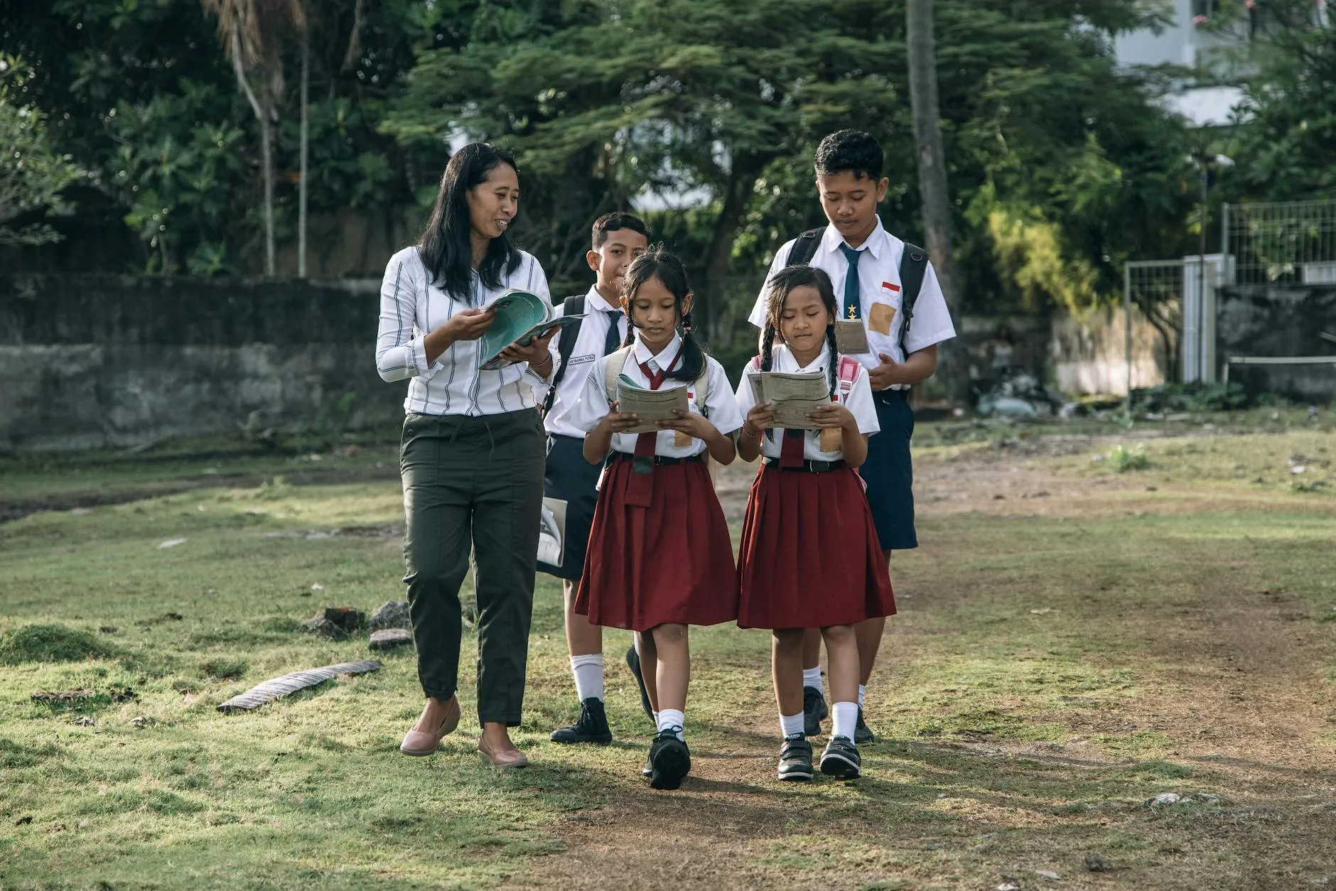 Students with teacher walking outdoors