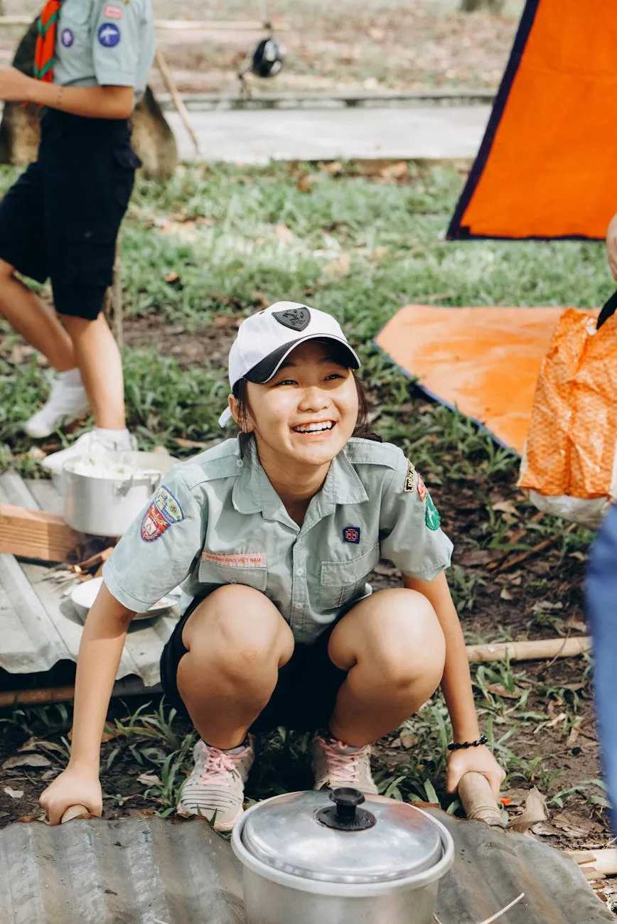 Scout cooking outdoors at campfire