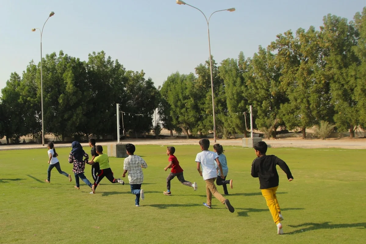 Young people playing wide games outdoors