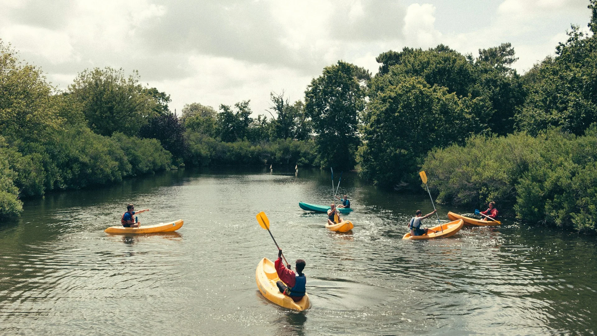 Young people kayaking on calm water