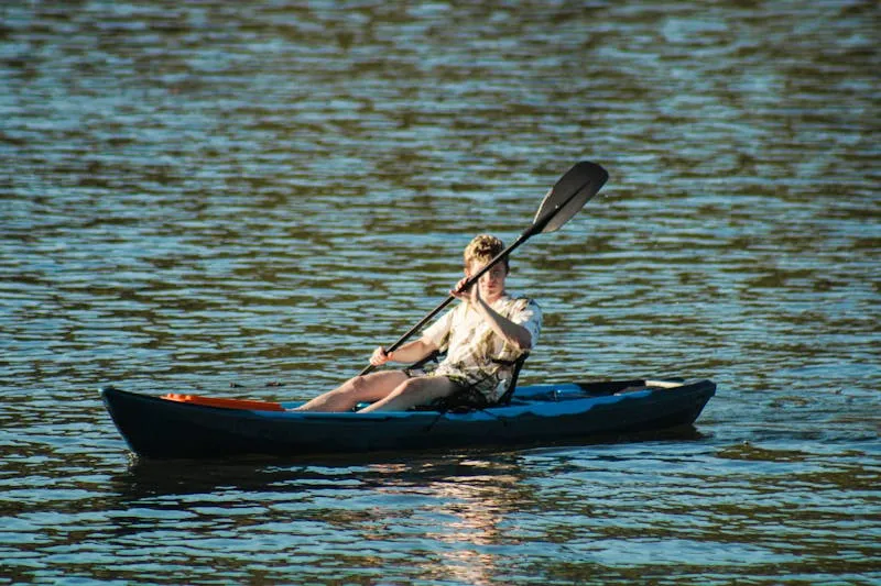 Youth group paddling canoes