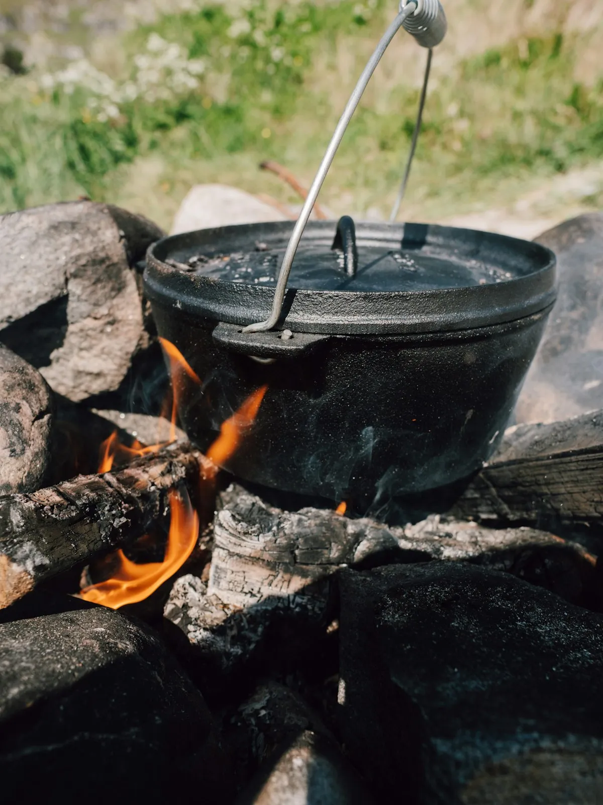 Youth group cooking over campfire