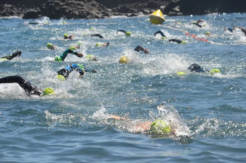 Swimmers in lake with safety buoys