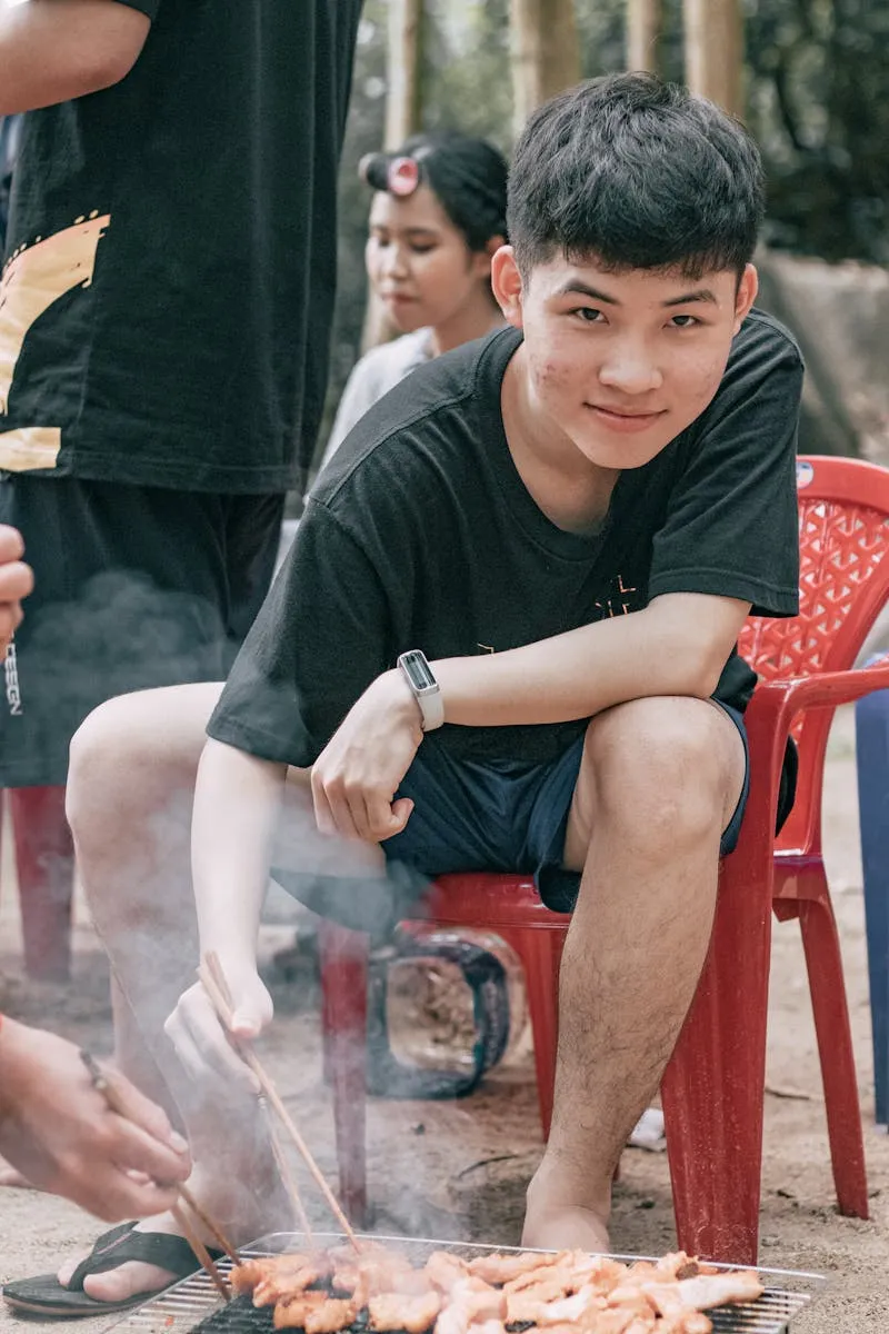 Young people enjoying outdoor barbecue