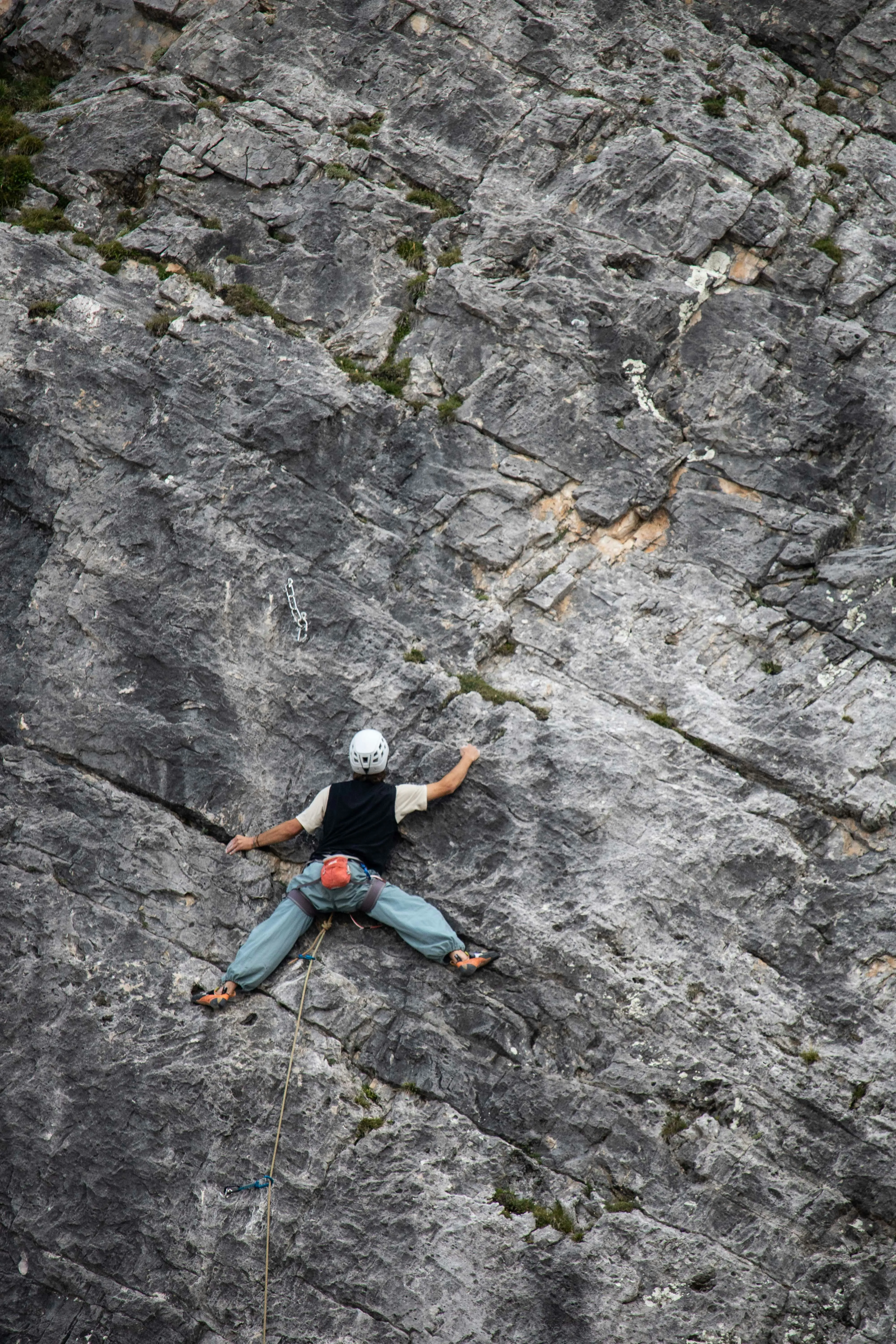 Young climber on natural rock face